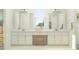 Bright bathroom featuring a double vanity with white cabinets, granite countertop, and a makeup vanity area at 31556 Cardinal Yard Dr, San Antonio, FL 33576