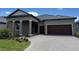 Beautiful exterior of a single-story home featuring a tile roof and a two-car garage at 31556 Cardinal Yard Dr, San Antonio, FL 33576