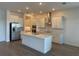 Modern kitchen with white cabinets, stainless steel appliances, and a center island with quartz countertops at 31556 Cardinal Yard Dr, San Antonio, FL 33576
