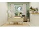 Stylish home office with neutral tones, featuring a modern desk, shelving, and natural light for a productive workspace at 31556 Cardinal Yard Dr, San Antonio, FL 33576