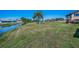 Expansive backyard overlooking a serene canal with lush landscaping and clear blue skies at 3847 Lighthouse Way # 3847, New Port Richey, FL 34652