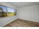 Empty bedroom featuring modern flooring and a large window overlooking a peaceful water view at 3847 Lighthouse Way # 3847, New Port Richey, FL 34652