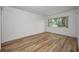 Bright bedroom with wood floors and natural light, perfect for relaxing and unwinding at 3847 Lighthouse Way # 3847, New Port Richey, FL 34652