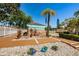 Charming community mural surrounded by decorative stones and well-maintained shrubbery at 3847 Lighthouse Way # 3847, New Port Richey, FL 34652