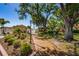 Landscaped pathway with lush greenery leads to a gated community entrance, offering a serene ambiance at 3847 Lighthouse Way # 3847, New Port Richey, FL 34652