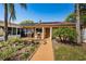 Charming home exterior featuring lush landscaping and a cozy patio area at 3847 Lighthouse Way # 3847, New Port Richey, FL 34652
