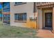 Exterior view of building featuring screened in porch, entry door, and lush green landscaping at 3847 Lighthouse Way # 3847, New Port Richey, FL 34652