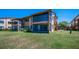 Exterior view showcasing a screened-in patio area with outdoor access and lush green surroundings at 3847 Lighthouse Way # 3847, New Port Richey, FL 34652