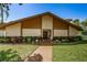 Community building with well-manicured lawn, shrubs, and sidewalk at 3847 Lighthouse Way # 3847, New Port Richey, FL 34652