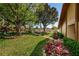 Well-maintained grounds with lush landscaping and mature trees leading to the community pool at 3847 Lighthouse Way # 3847, New Port Richey, FL 34652