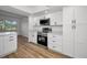 Bright kitchen featuring stainless steel appliances, white cabinets, and quartz countertops at 3847 Lighthouse Way # 3847, New Port Richey, FL 34652
