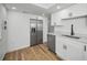 Well-lit kitchen with stainless steel appliances, white cabinets, and ample counter space at 3847 Lighthouse Way # 3847, New Port Richey, FL 34652