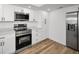 Bright kitchen featuring stainless steel appliances, white cabinets, and quartz countertops at 3847 Lighthouse Way # 3847, New Port Richey, FL 34652