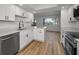 Bright kitchen featuring stainless steel appliances, white cabinets, and quartz countertops at 3847 Lighthouse Way # 3847, New Port Richey, FL 34652