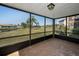 Screened lanai offering serene views of the water and surrounding landscape at 3847 Lighthouse Way # 3847, New Port Richey, FL 34652