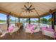 Charming pergola with lake views, seating and festive decorations at 3847 Lighthouse Way # 3847, New Port Richey, FL 34652