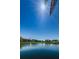 Waterfront condos overlooking the tranquil pond, with a backdrop of clear blue skies and lush greenery at 3847 Lighthouse Way # 3847, New Port Richey, FL 34652