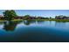 Scenic view of the waterfront condos from across the pond, providing a tranquil and picturesque living environment at 3847 Lighthouse Way # 3847, New Port Richey, FL 34652