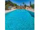 Spacious and inviting community pool with clear blue water and comfortable lounge chairs at 3847 Lighthouse Way # 3847, New Port Richey, FL 34652