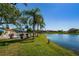 Beautiful waterfront view with a community pool, lounge chairs, and scenic surroundings at 3847 Lighthouse Way # 3847, New Port Richey, FL 34652