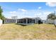 Wide backyard with a screened porch, perfect for outdoor living and activities at 4715 W Montgomery Ave, Tampa, FL 33616