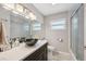 Bathroom featuring a sleek vanity with modern fixtures and glass-enclosed shower at 4715 W Montgomery Ave, Tampa, FL 33616