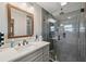 Modern bathroom features a glass-enclosed shower and stylish vanity with framed mirror at 4715 W Montgomery Ave, Tampa, FL 33616