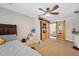 Bedroom with a wooden accent sliding door to ensuite bathroom and a ceiling fan at 4715 W Montgomery Ave, Tampa, FL 33616