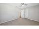 Clean bedroom featuring neutral carpet, paint, and a ceiling fan at 4715 W Montgomery Ave, Tampa, FL 33616