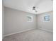 Cozy bedroom featuring neutral paint, carpet, and two windows at 4715 W Montgomery Ave, Tampa, FL 33616