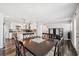 Dining room and kitchen featuring wood floors, granite countertops, and stainless steel appliances at 4715 W Montgomery Ave, Tampa, FL 33616