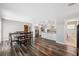 Bright dining room featuring wood floors, white cabinets, and stainless steel appliances at 4715 W Montgomery Ave, Tampa, FL 33616