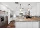 Kitchen featuring wood floors, granite countertops, white cabinets and stainless steel appliances at 4715 W Montgomery Ave, Tampa, FL 33616