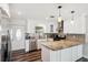 Updated kitchen with wood floors, granite countertops, stainless steel appliances, and ample counter space at 4715 W Montgomery Ave, Tampa, FL 33616