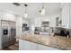 Modern kitchen with wood floors, granite countertops, white cabinets and stainless steel appliances at 4715 W Montgomery Ave, Tampa, FL 33616