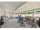 This screened-in porch has a seating area and exercise equipment, and houses laundry equipment at 4715 W Montgomery Ave, Tampa, FL 33616