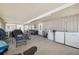 Enclosed back porch is large with exercise equipment, a seating area and laundry equipment at 4715 W Montgomery Ave, Tampa, FL 33616