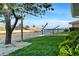 Lush backyard with well-maintained landscaping, waterfront access, and a boat lift at 4968 Southshore Dr, New Port Richey, FL 34652