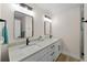 Updated bathroom with double sinks, granite countertops, modern fixtures, and wood-look flooring at 4968 Southshore Dr, New Port Richey, FL 34652