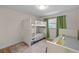 Shared bedroom featuring a bunk bed and an additional twin bed with green curtains and wood flooring at 4968 Southshore Dr, New Port Richey, FL 34652