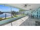 Spacious screened lanai with multiple ceiling fans, tile flooring, and a view of the waterfront at 4968 Southshore Dr, New Port Richey, FL 34652
