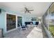 Relaxing screened lanai with views of the canal, comfortable seating, and natural light at 4968 Southshore Dr, New Port Richey, FL 34652