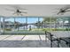 Screened lanai featuring views of the canal with a table and seating for outdoor living at 4968 Southshore Dr, New Port Richey, FL 34652
