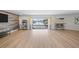 Spacious open-concept living space with wood floors, lots of light, and sliding door access to outdoor patio at 4968 Southshore Dr, New Port Richey, FL 34652
