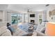 Bright living room featuring a decorative fireplace, tile flooring and a sliding glass door that opens to the outdoor space at 4968 Southshore Dr, New Port Richey, FL 34652