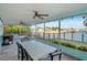 Expansive screened patio with a dining table and views of the tranquil waterfront at 4968 Southshore Dr, New Port Richey, FL 34652