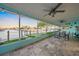 Enclosed patio with stylish ceiling fans, canal views, and tiled floors is perfect for outdoor relaxation and entertaining at 4968 Southshore Dr, New Port Richey, FL 34652