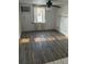 Bedroom with dark wood laminate flooring, ceiling fan and window at 5829 32Nd N St, St Petersburg, FL 33714