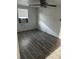 Bedroom features dark wood laminate flooring, ceiling fan and window at 5829 32Nd N St, St Petersburg, FL 33714