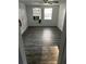 Living room with dark wood laminate flooring, two windows, and a ceiling fan at 5829 32Nd N St, St Petersburg, FL 33714